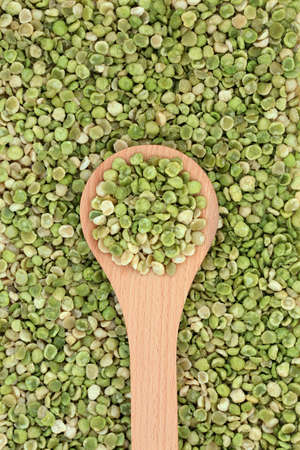 Organic roasted green peas healthy food in a wooden spoon