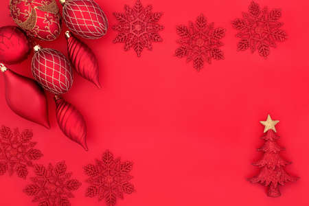 Christmas red bauble decorations on red with tree, snowflake, droplet and ball baubles. Festive...