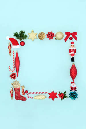 Minimal square Christmas wreath with holly, fir, mince pies and traditional decorations. On pastel blue background. Abstract composition for Xmas and New Year.の写真素材