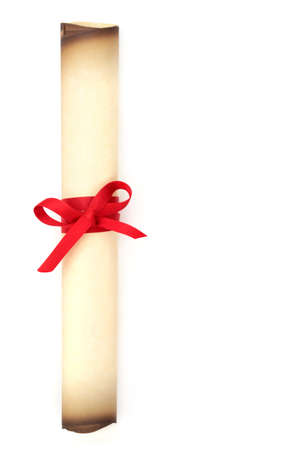 Old parchment scroll rolled up and tied with red ribbon. On white background with copy space....