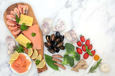 Healthy nourishing food for immune system boost with seafood, vegetables, fruit, herbs, spice. Foods with herbal medicine high in antioxidants, anthocayanins, protein, fibre, vitamins, omega 3.の写真素材