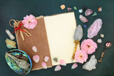 Magical occult equipment for fertility crystal healing and purification with smudge stick, crystals, rose flowers, corn dolly, hemp notebook for spells.の写真素材