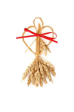 Sweetheart style corn husk doll  for lovers. Pagan wicca symbol of fertility for success. Traditional old fashioned  bountiful harvest concept. On white top view flat lay.の写真素材