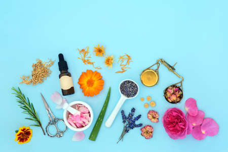 Flowers and Herbs for natural plant based aromatherapy skincare essential oil. Can ease psoriasis, eczema, acne and wounds. Natural summer floral beauty health care on blue background.の写真素材