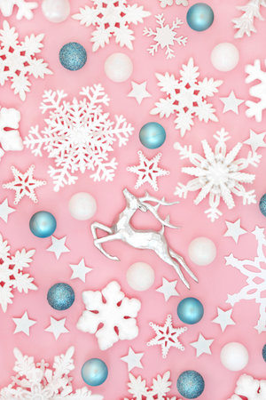 Fantasy Christmas reindeer, snowflake and tree bauble decoration background on pink. Magical  north pole design for winter, Xmas Eve and New Year holiday season.の写真素材