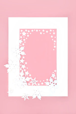 Star and snowflake Christmas abstract festive background border on pink with white frame. Fantasy design for winter, Xmas and New Year holiday Season.の写真素材