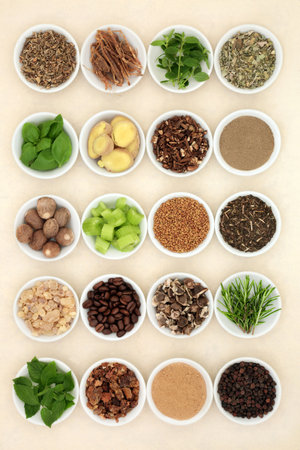 Nervine health foods to support and energise the nervous system. Healthy natural alternative health care. Ingredients in bowls on hemp paper background.の写真素材