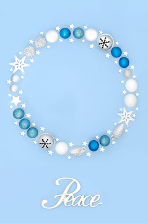 Peace on earth sign festive Christmas wreath with tree baubles and stars on pastel blue background. to all Men design concept.の写真素材
