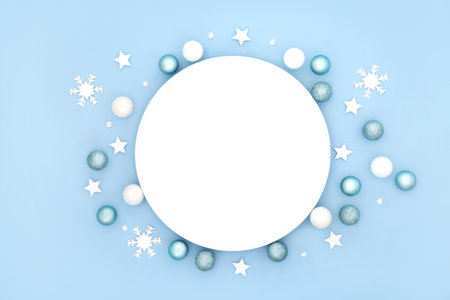 Christmas table place setting with plate, white and pastel blue frosted sparkling decorations. Abstract minimal design for Xmas festive holiday season and New Year.の写真素材