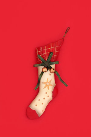 Christmas stocking tree ornament decoration vintage metal retro style on red background. Old fashioned symbol of Xmas Eve.の写真素材