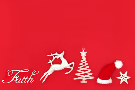 Christmas eve faith and wish concept on red background with santa hat, sign, reindeer and star tree decorations. Fun exciting Xmas believe composition for the holiday season.の写真素材