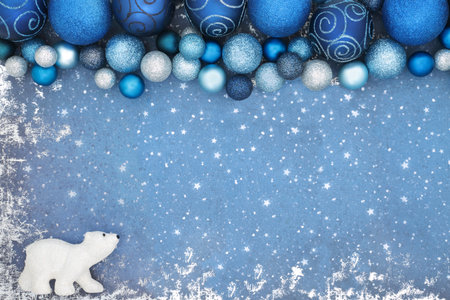 Christmas North Pole background concept with polar bear and blue sparkling tree baule decorations. Festive border composition for the Xmas holiday season on grunge.の写真素材