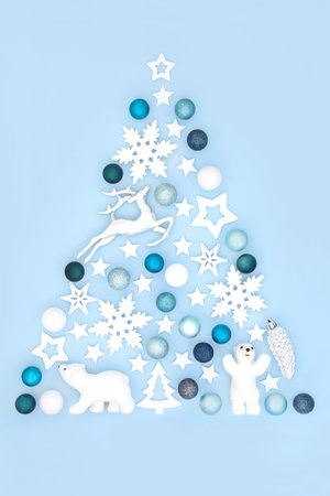 Norgh Pole Christmas tree abstract concept shape with of reindeer, snowfalke and polar bear ornaments and Xmas symbols on pastel blue background.の写真素材