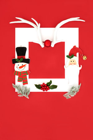 Christmas holiday background with festive symbols of reindeer antlers, santa, snowman, fir snow and holly on red background. Abstract design for Xmas and New Year holiday season.の写真素材