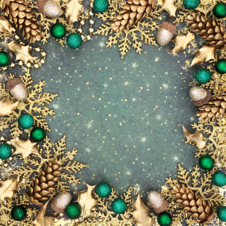 Christmas gold glitter snowflake design on grunge background border with sparkling tree decorations for the festive holiday season with acorns, balls, pine cones, holly leaves.の写真素材