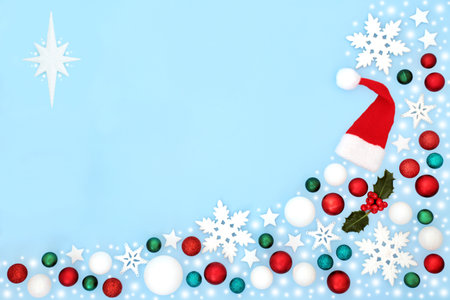 Christmas snow and tree decorations with snow and snowflake theme. Festive background border on pastel blue minimal composition for the holiday season. Flat lay top view.の写真素材