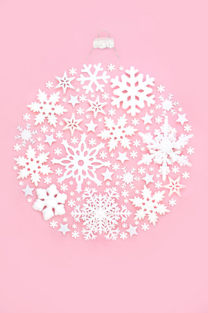 Christmas tree snowflake bauble round shape decoration on pink background. Festive ornate abstract concept for winter Xmas and New Year.の写真素材