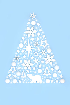 Magical Christmas tree concept shape with abstract snow, polar bear, star and snowflake ornaments on pastel blue background. Fantasy design for winter, Xmas, New Year.の写真素材