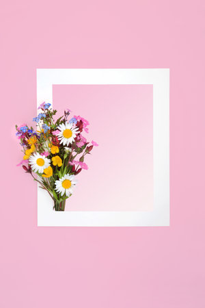 English Spring wildflower bunch with background border on gradient pink with white frame. Minimal floral nature, beautiful arrangement for birthday, Valentines, anniversary, Mothers Day, Easter.の写真素材