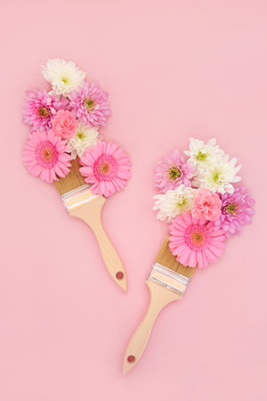Surreal paintbrush abstract splash of summer flowers. Nature composition with rose, chrysanthemum, gerbera and carnation flora. Minimal floral creative layout on pink background.の写真素材