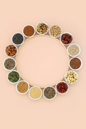 Wreath of health food ingredients high in essential fatty acids. Lipids containing unsaturated good fats for healthy heart and cholesterol levels with nuts, seeds, legumes and grain.の写真素材