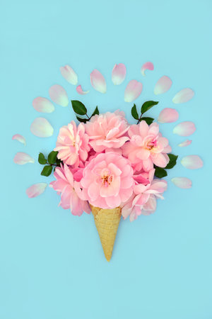 Surreal pink rose flower ice cream waffle cone with petals on pastel blue background. Minimal abstract summer creative floral fun nature concept.の写真素材