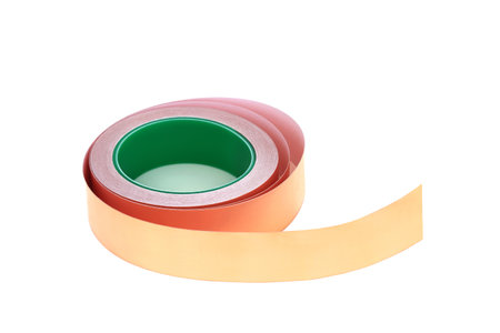 Slug and snail copper foil tape repellent, self adhesive, used to deter slugs, snails via mild electric shock, from eating garden plants, flowers, vegetables and fruit. On white, copy space.の写真素材