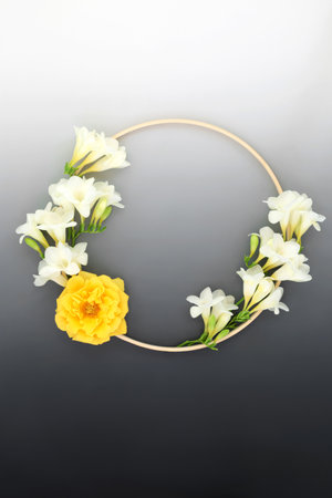 Floral wreath for in memorium sympathy card with freesia and rose flower and wooden frame. Minimal condolence round shape symbol on gradient grey. RIP concept.の写真素材