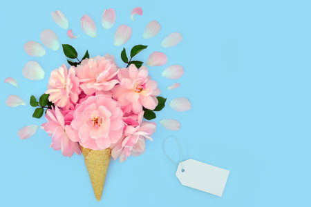 Surreal pink rose flower ice cream cone fantasy gift on pastel blue background. Minimal summer creative food art fun nature concept. Valentines Day, Mothers Day, Anniversary or birthday.の写真素材