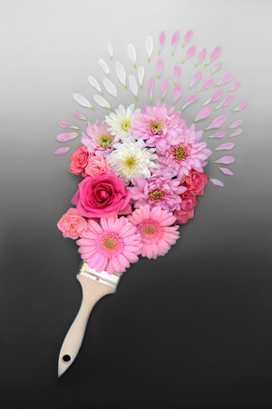 Paint splash surreal painting abstract with summer flowers. Nature composition with paintbrush and flora. Minimal fun creative layout on gradient grey background.の写真素材