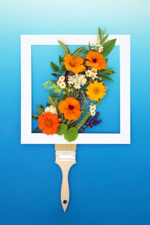 Surreal abstract paintbrush concept with edible summer flowers and herb painting splash. Minimal creative nature floral food design on gradient blue white background with frame. Flat lay.の写真素材
