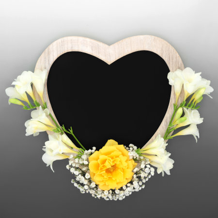 Heart shaped rustic wooden frame with chalkboard and flowers. Suitable for In Memorium card, funeral invitation, mourning, RIP concept. On gradient grey.の写真素材