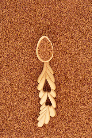 Camelina seed immune system boosting health food with love spoon. Healthy benefits for low cholesterol, vitamin E for skincare, is anti inflammatory. Flat lay, top view.の写真素材
