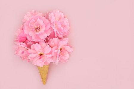 Rose flower surreal ice cream waffle cone design on pink background. Summer flowers minimal abstract floral creative art trendy concept. For Valentines, wedding, Mothers Day, anniversary or birthday design.の写真素材