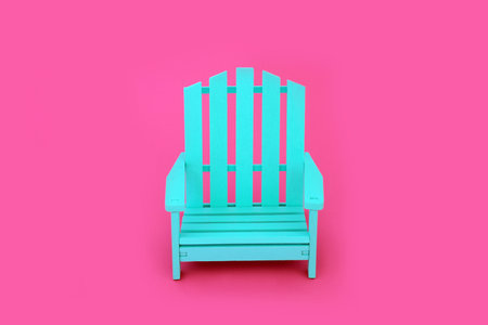 Trendy solitary slatted wooden blue chair on vivid pink background. Independent, modern contemporary stylish furniture, colour, contrast, concept. Copy space.の写真素材