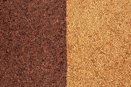 Gold and brown flax seed background. Natural organic vegan health food for low cholesterol, blood pressure and blood sugar. Helps with IBS, is a natural laxative.の写真素材