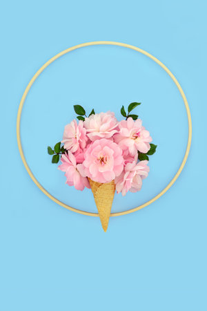 Rose flower bizarre ice cream cone minimal design on pastel blue background with wooden round frame. Surreal summer creative fun floral nature concept.の写真素材