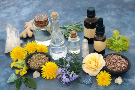 Crystal healing with herbs and flowers for naturopathic herbal plant medicine and flowers remedies. Wicca, pagan occult nature theme with essential oils for medicinal preparation.の写真素材