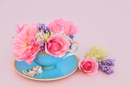Surreal adaptogen rose, valerian, lavender and elder flower design in tea cup on pink. Fun food...