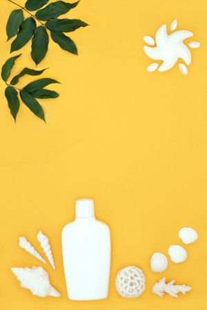 Suntan moisturizing lotion bottle for natural skincare protection with seashell soaps, shells and starfish sun on yellow background. Abstract design for the holiday season.の写真素材