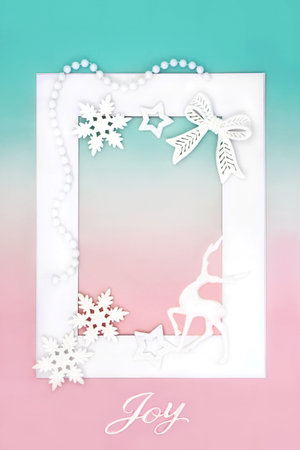 Christmas reindeer white tree decorations on white frame on pink and green background. Festive North pole fantasy theme for the holiday season.の写真素材