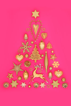 Christmas tree surreal gold bauble decoration. Festive concept symbol for holiday season, greeting card, gift tag, label on pink.の写真素材