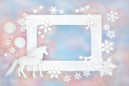 Christmas unicorn and white bauble ornaments on blue pink sky background white frame. Festive concept for holiday season, greeting card, gift tag, label. invitation.の写真素材