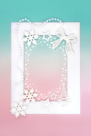 Christmas tree and bauble ornaments on white frame on green pink background with snowflakes. Festive abstract fantasy north pole border design for the holiday season.の写真素材