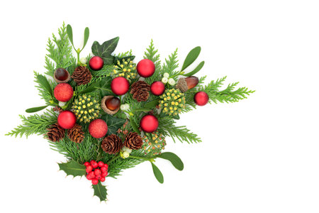 Christmas traditional winter flora greenery with red ball decorations on white background. Festive nature bouquet for the holiday season, Yule, Noel, New Year.の写真素材