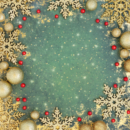 Christmas holly berry and gold bauble decorations on grunge green background. Abstract festive design for greeting card, invitation, Yule, Noel.の写真素材