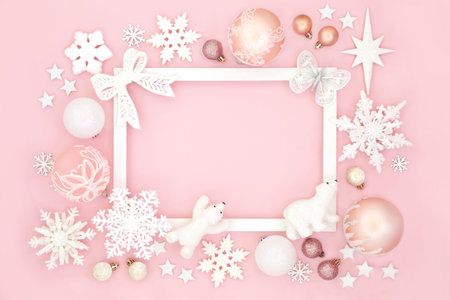 Merry Christmas north pole background border of bauble decorations, white  frame. Happy holidays festive design for greeting card, label, gift tag, Noel ,Yule, winter on pink.の写真素材
