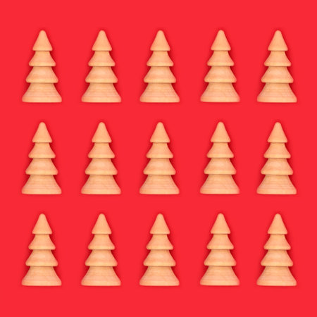 Christmas tree wooden ornament design on red background. Eco friendly decoration for Merry Christmas Noel Yule greeting card, gift tag.の写真素材