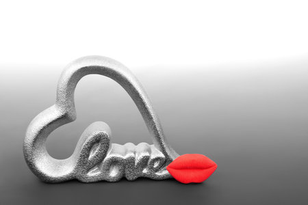 Love heart shape sign with luscious red lips on gradient gray. Minimal Valentines Day romantic I love you abstract concept.の写真素材