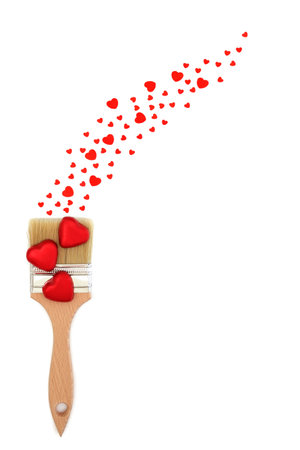 Love heart painting with paintbrush and confetti hearts on white background. Fantasy abstract surreal concept for romantic Valentines Day.の写真素材